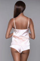 NEWYORKLISTED Intimate Apparel Collection: Woman wearing a white satin nightgown against a gray background