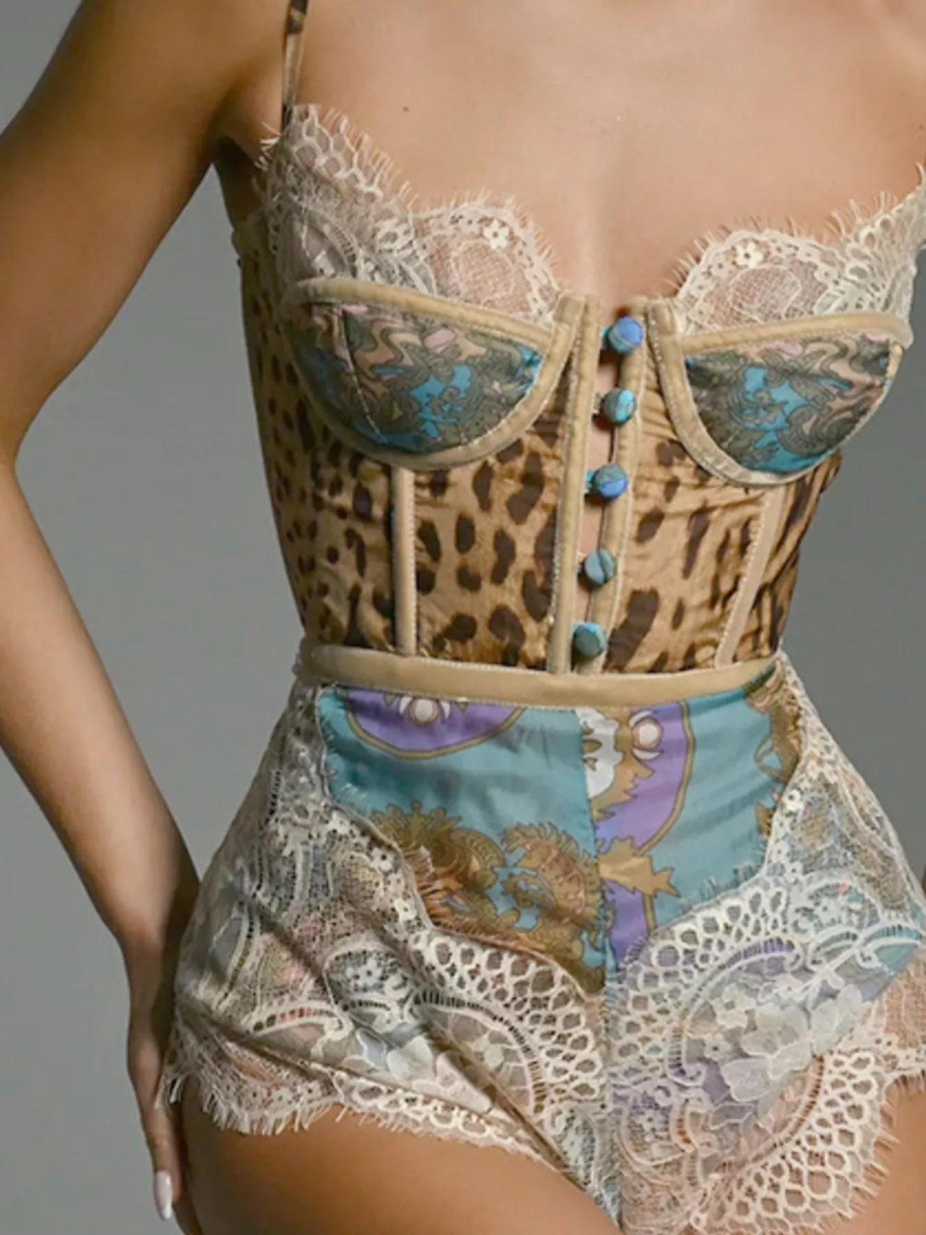 NEWYORKLISTED INTIMATE APPAREL: Leopard print corset with lace details on a gray background