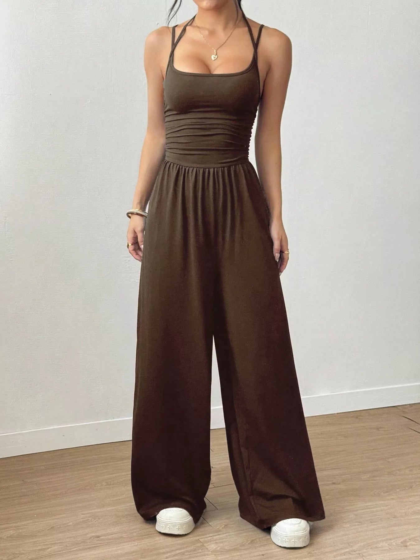 NEWYORKLISTED Comfort Collection: Woman wearing a burgundy jumpsuit on a plain background