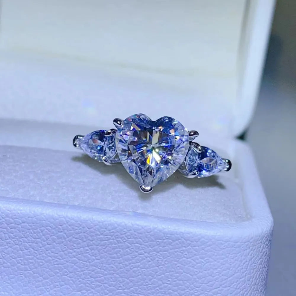 NYLD Glamour Collection By NEWYORKLISTED: Heart-shaped diamond ring with two pear-shaped diamonds on a white background