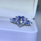 NYLD Glamour Collection By NEWYORKLISTED: Heart-shaped diamond ring with two pear-shaped diamonds on a white background