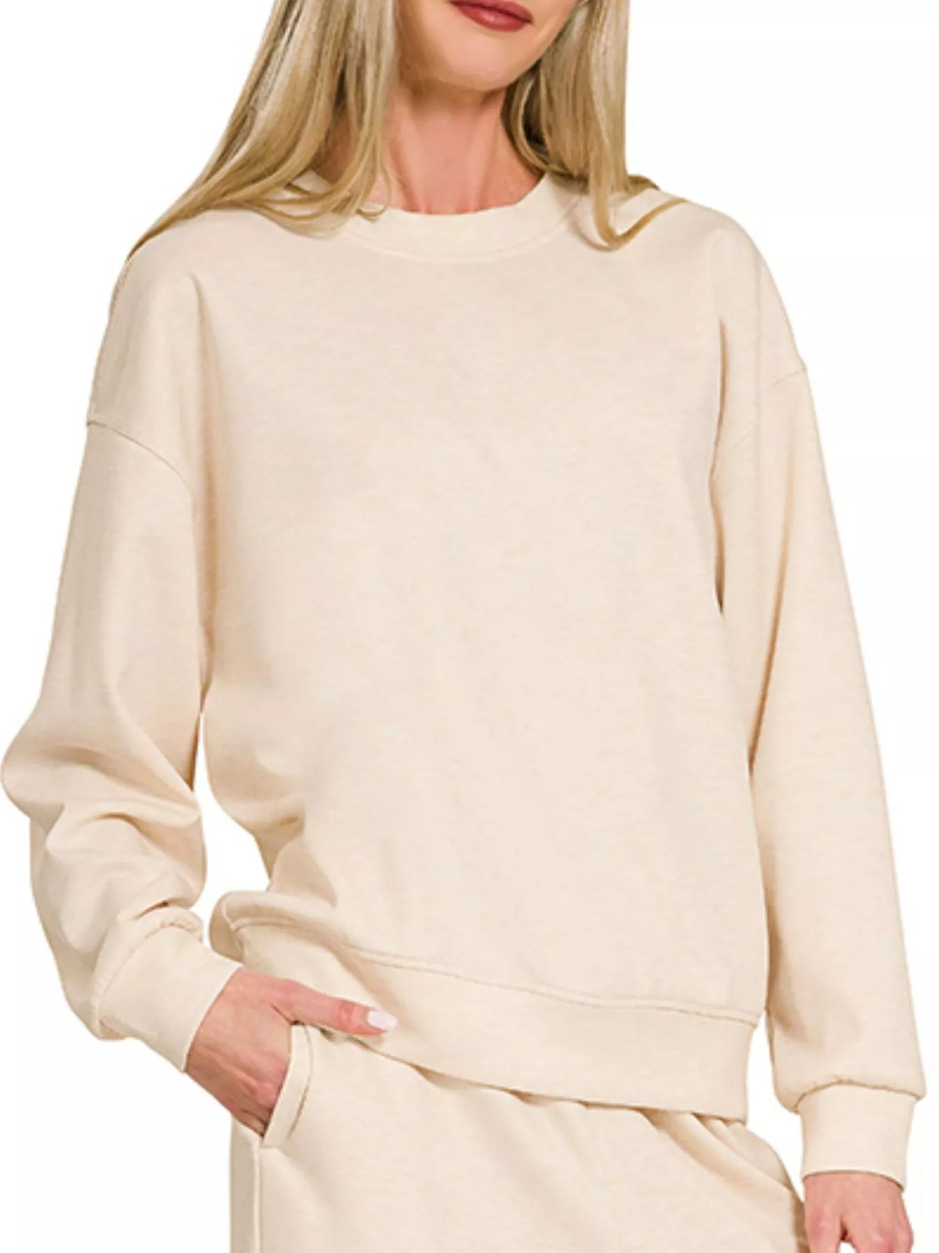 NEWYORKLISTED STYLE COLLECTION: Beige sweatshirt worn by a person on a white background