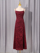 NEWYORKLISTED STYLE COLLECTION: Burgundy dress on a mannequin against a gray curtain background