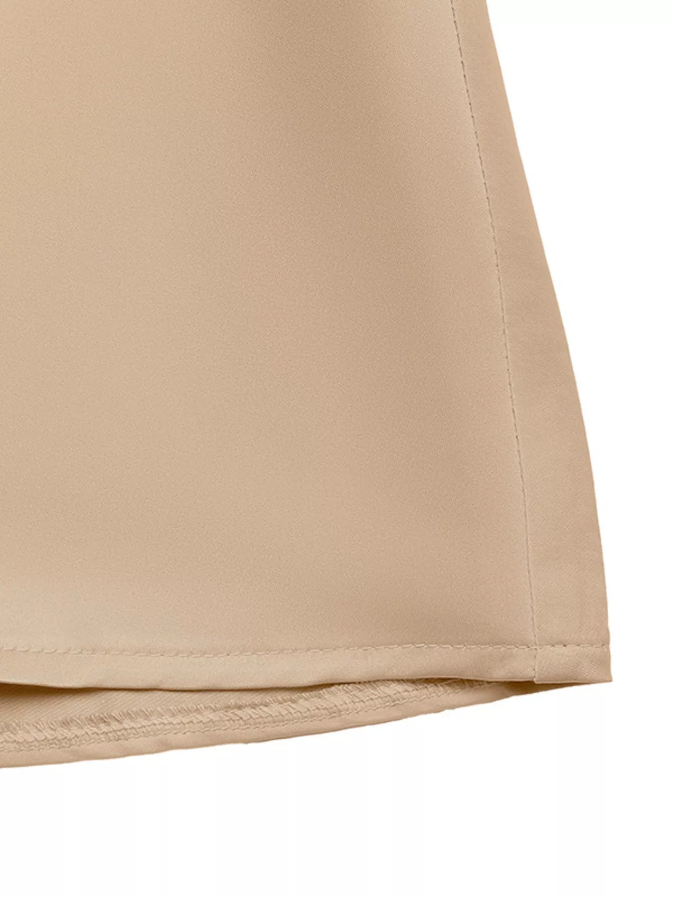 NEWYORKLISTED RUNWAY STYLE: Close-up of beige shorts on a white background