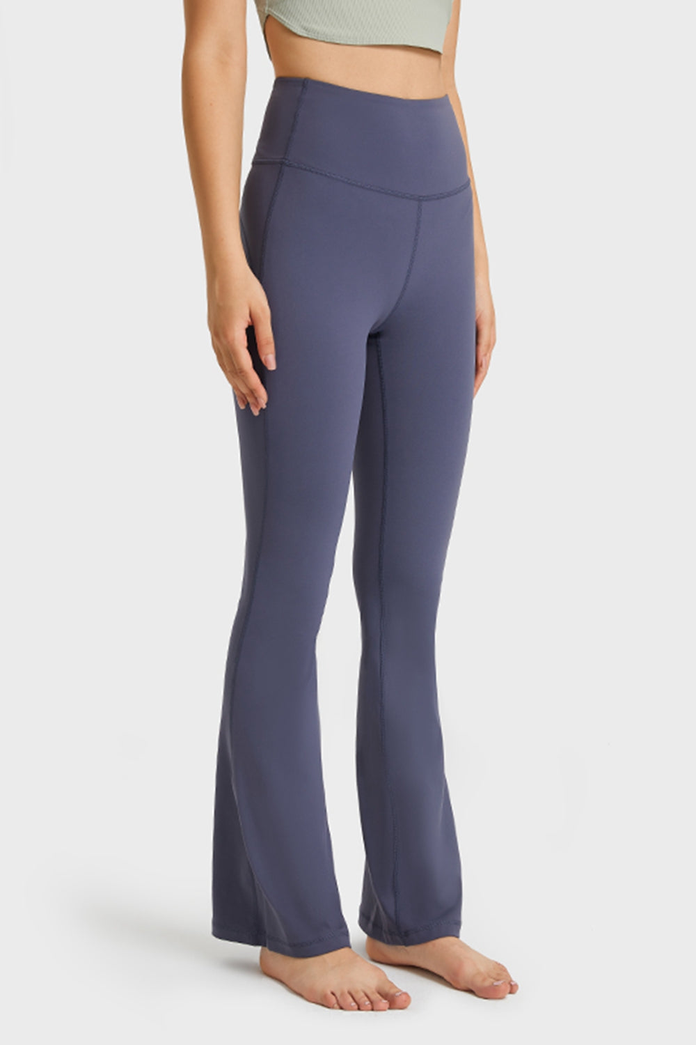NEWYORKLISTED ACTIVEWEAR COLLECTION: Person wearing purple flared pants on a white background