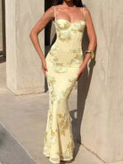 NEWYORKLISTED STYLE COLLECTION: Woman wearing a light yellow evening gown with floral embroidery against a neutral background
