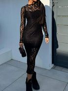 NEWYORKLISTED Valentine's Day Specials: Model wearing a black lace outfit standing against a light-colored wall.