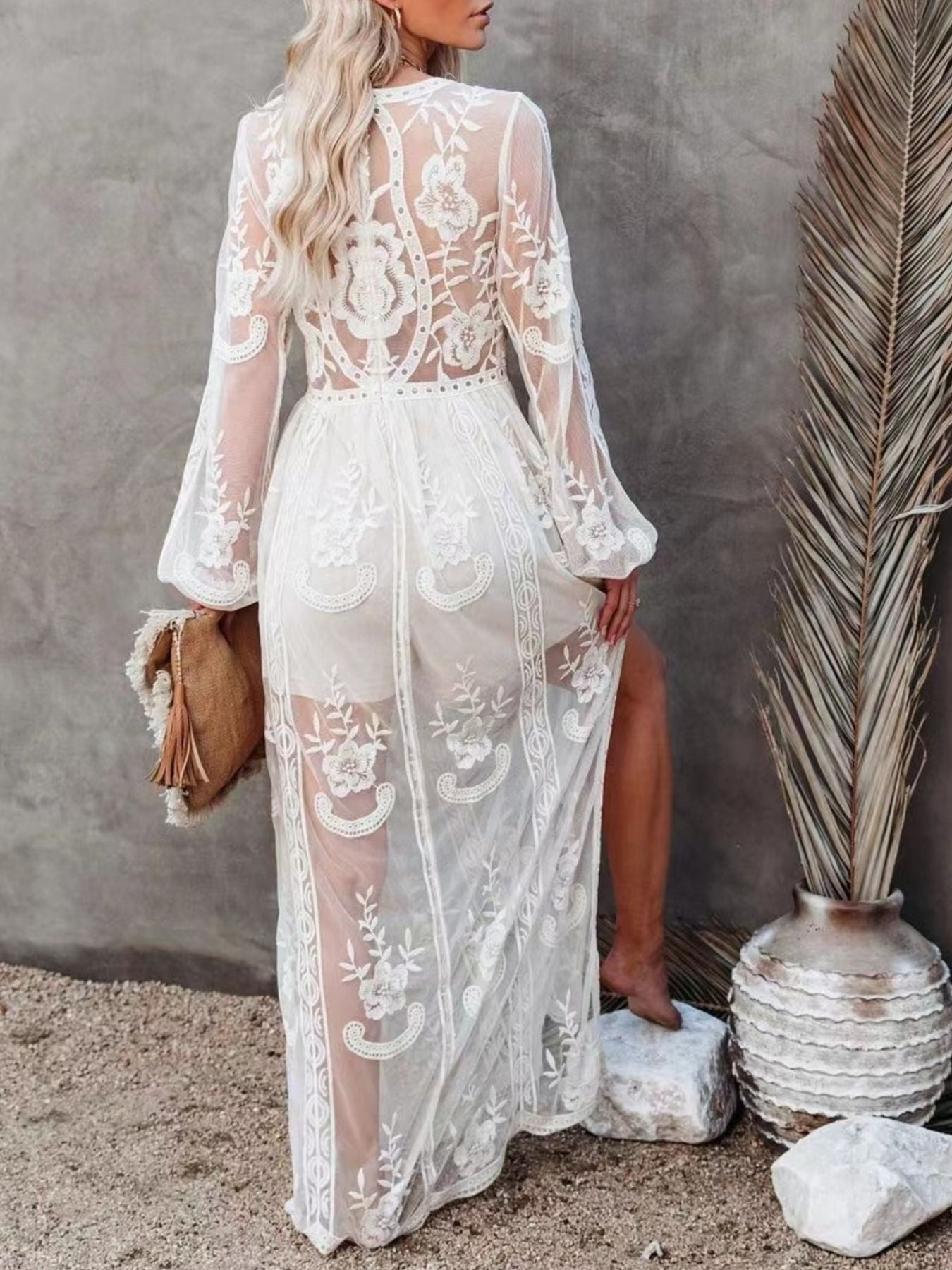 NEWYORKLISTED STYLE COLLECTION: Woman wearing a white lace dress with long sleeves in a natural setting.
