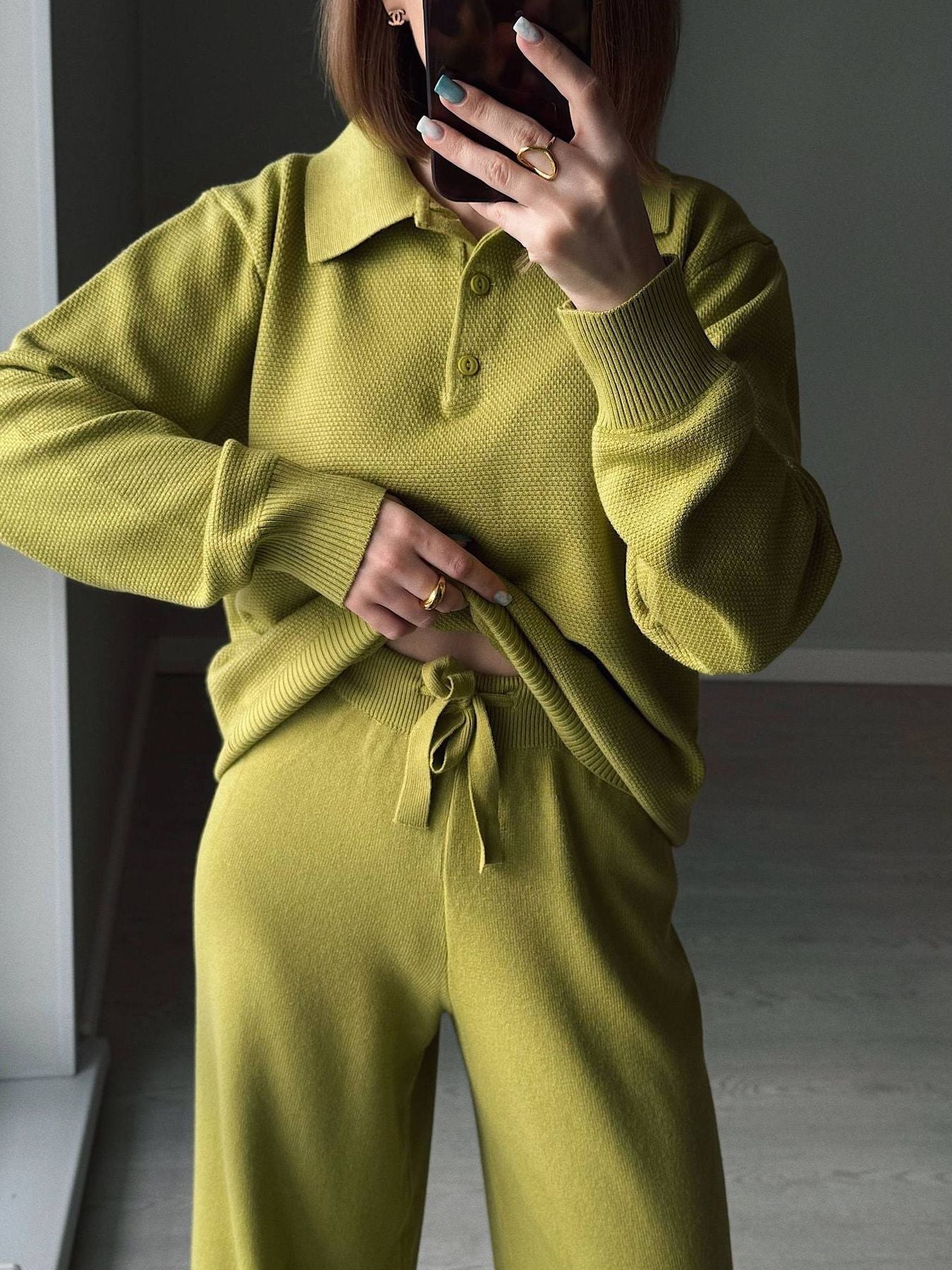 NEWYORKLISTED Comfort Collection: Person wearing a green knit outfit with a plain background