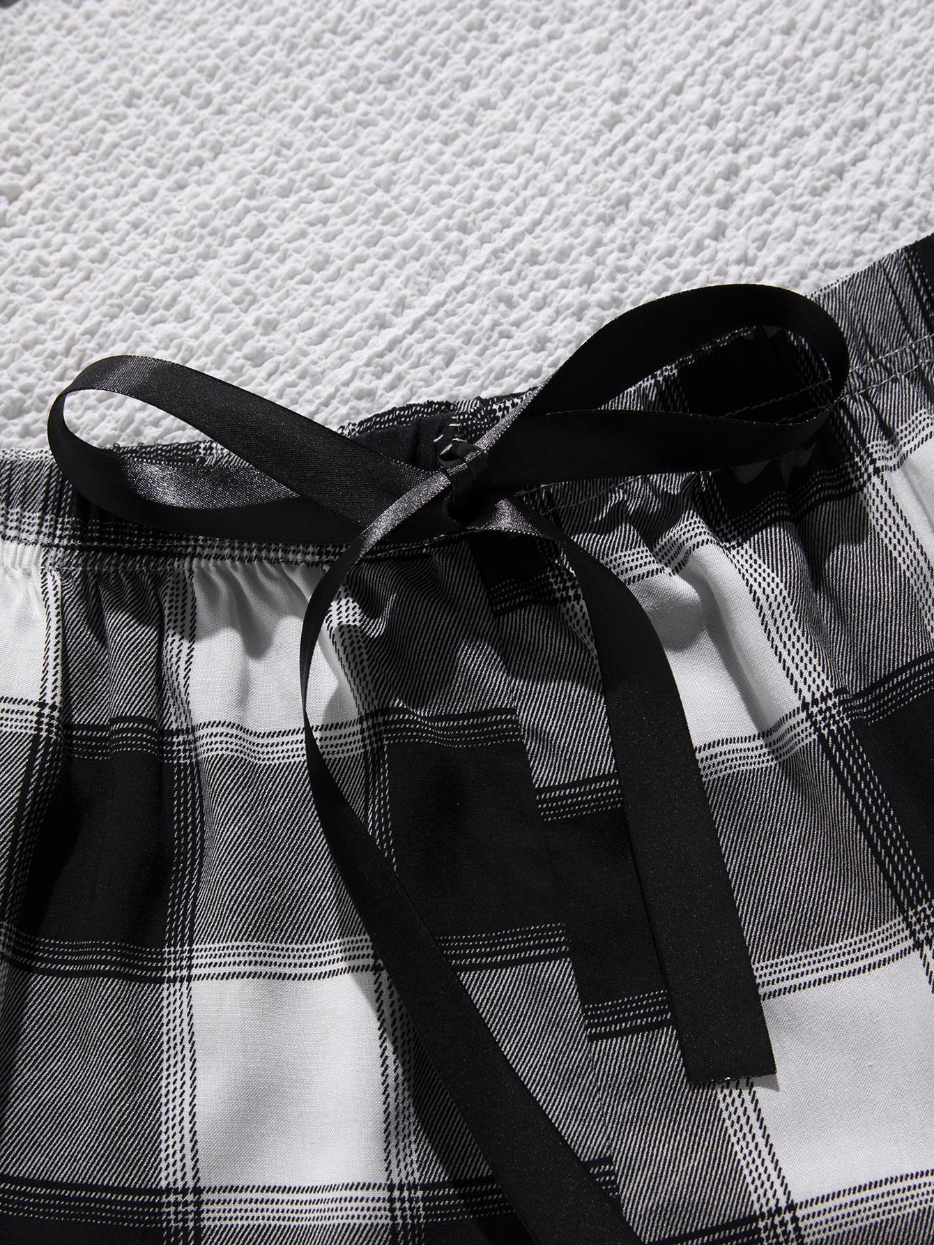 Plaid shorts with a black ribbon on a textured white background