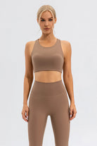 NEWYORKLISTED ACTIVEWEAR COLLECTION: Woman wearing a brown sports bra and leggings set on a white background