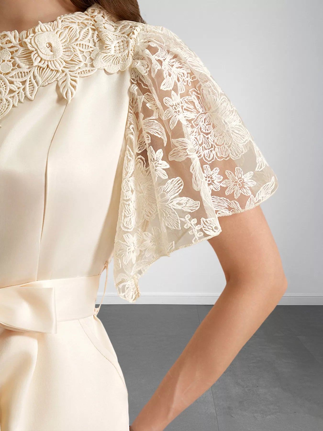 NEWYORKLISTED STYLE COLLECTION: Cream-colored dress with floral lace details on a plain background