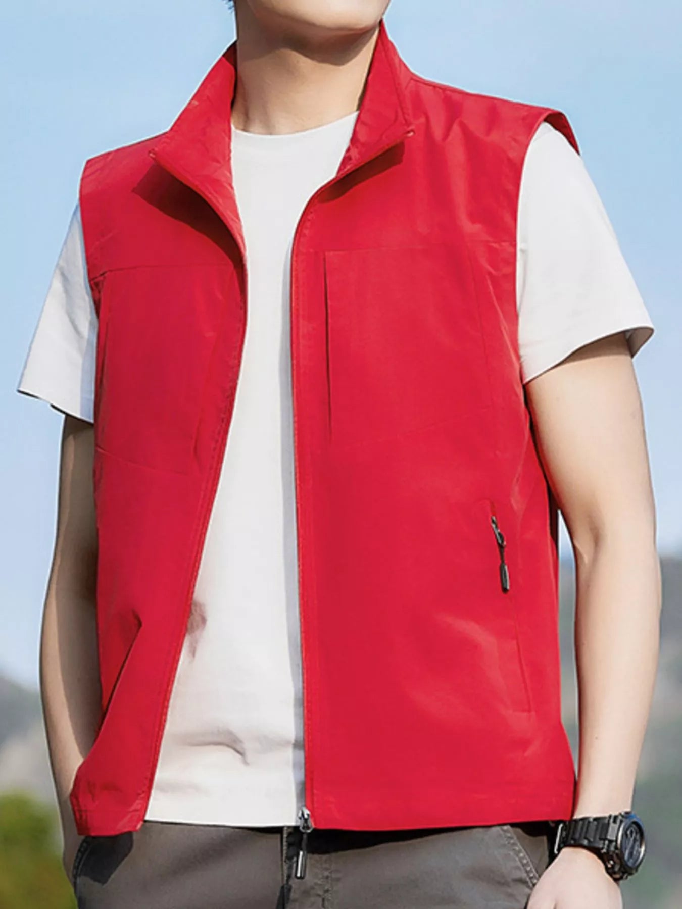 NEWYORKLISTED ATLAS MEN's COLLECTION: Person wearing a red vest over a white shirt with a blurred background