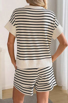 NEWYORKLISTED STYLE COLLECTION: Person wearing a black and white striped outfit indoors.