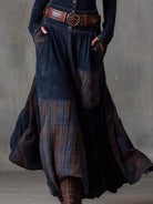 NEWYORKLISTED Style Collection: Long dark blue patchwork skirt with plaid pattern worn by a person against a gray background