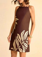 NEWYORKLISTED STYLE COLLECTION: Woman wearing a brown dress with white leaf patterns on a beige background