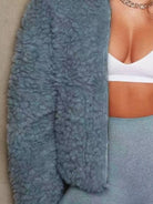 Close-up of a textured blue garment with a neutral background