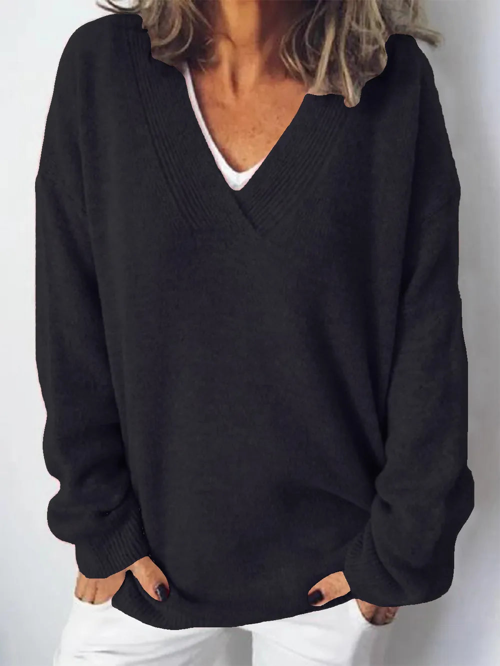 NEWYORKLISTED STYLE COLLECTION V-Neck Dropped Shoulder Sweater in soft knit black fabric on a minimalist white background 