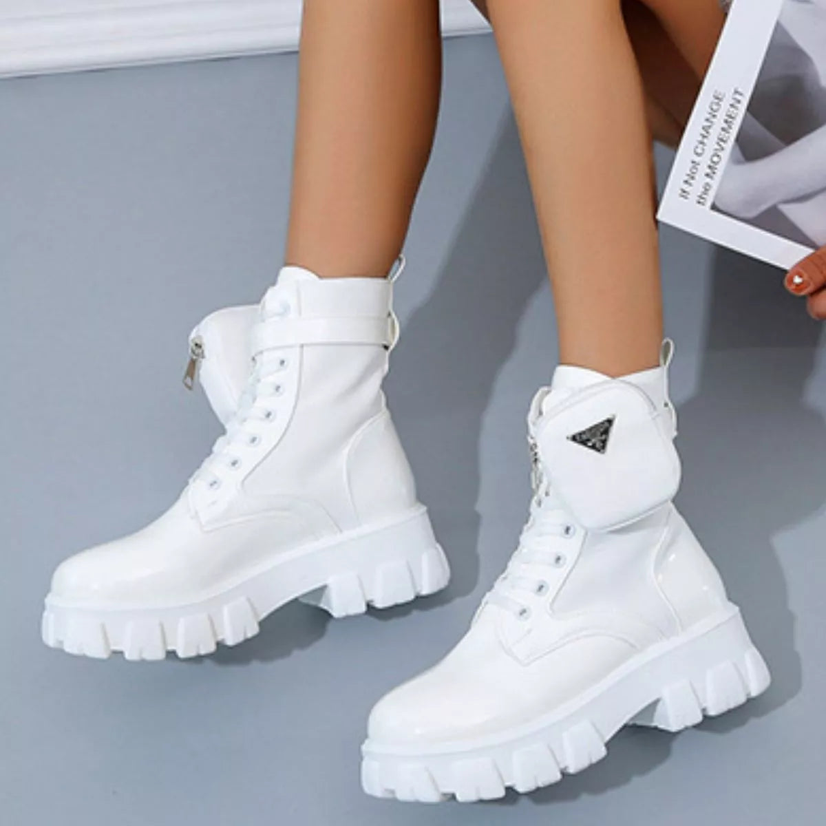 NEWYORKLISTED SHOE COLLECTION: White platform boots worn by a person on a gray background