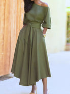 NEWYORKLISTED STYLE COLLECTION: Woman wearing an olive green dress with a blurred background