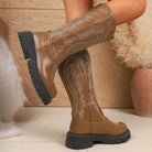 NEWYORKLISTED SHOE COLLECTION: Round Toe Block Heels Boots: Brown cowboy boots with black soles worn by a person, against a neutral background.