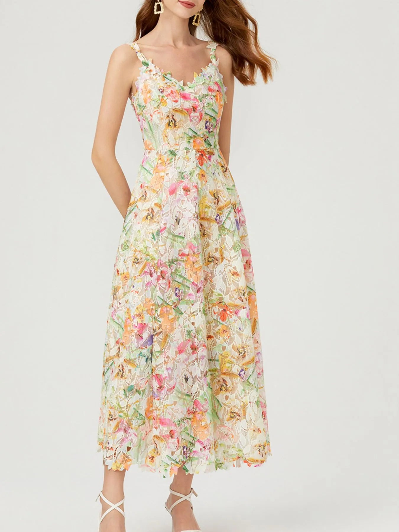 NEWYORKLISTED STYLE COLLECTION: Woman wearing a floral dress on a white background