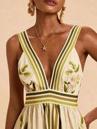 NEWYORKLISTED STYLE COLLECTION: Woman wearing a floral dress with green and yellow stripes on a beige background