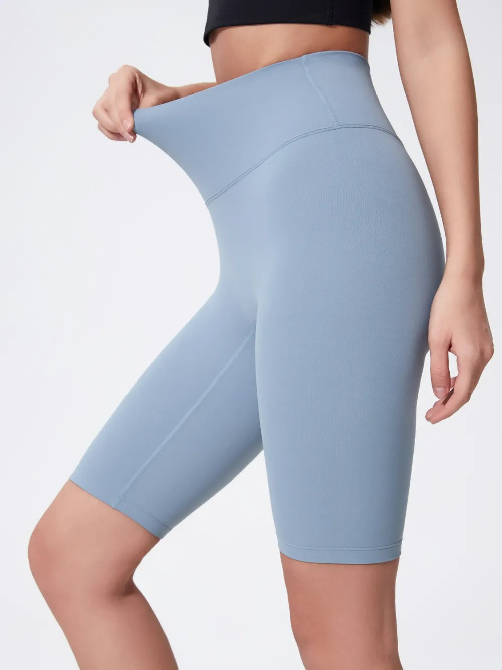 NEWYORKLISTED ACTIVEWEAR COLLECTION: Light blue athletic shorts worn by a person on a plain background