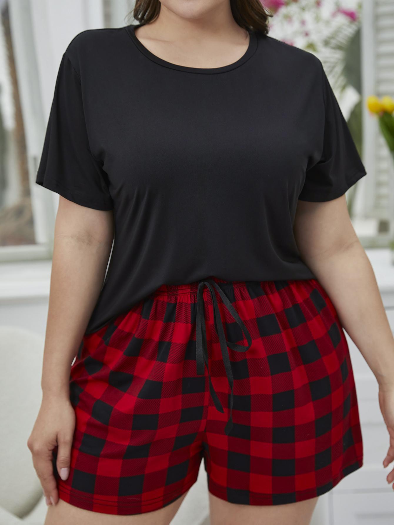 NEWYORKLISTED Intimate Apparel: Person wearing a black top and red plaid shorts outdoors.