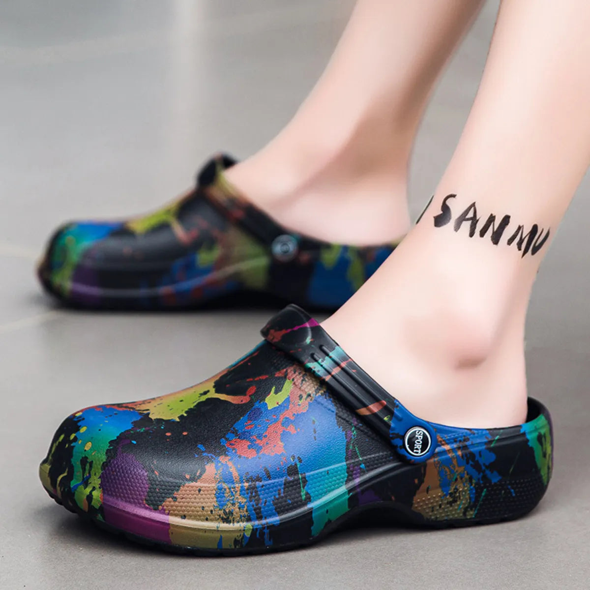 NEWYORKLISTED STYLE COLLECTION: Colorful splatter-patterned clogs worn by a person on a neutral background