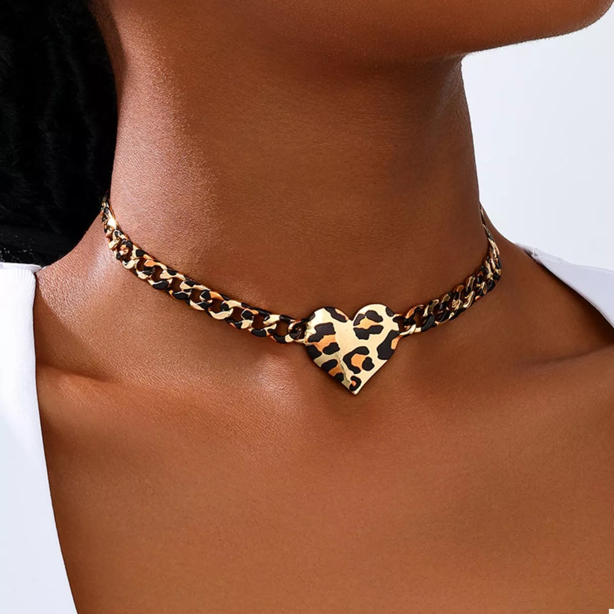 NYLD GLAM by NEWYORKLISTED: model is wearing a leopard print chocker with heart shaped pendant 