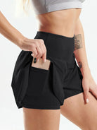 NEWYORKLISTED Activewear: Person wearing black athletic shorts with a pocket, holding a phone.