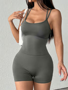 NEWYORKLISTED ACTIVEWEAR COLLECTION: Woman wearing a gray bodysuit against a light gray background