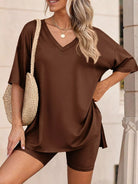 NEWYORKLISTED COMFORT COLLECTION: Woman wearing a brown outfit with a straw bag against a neutral background