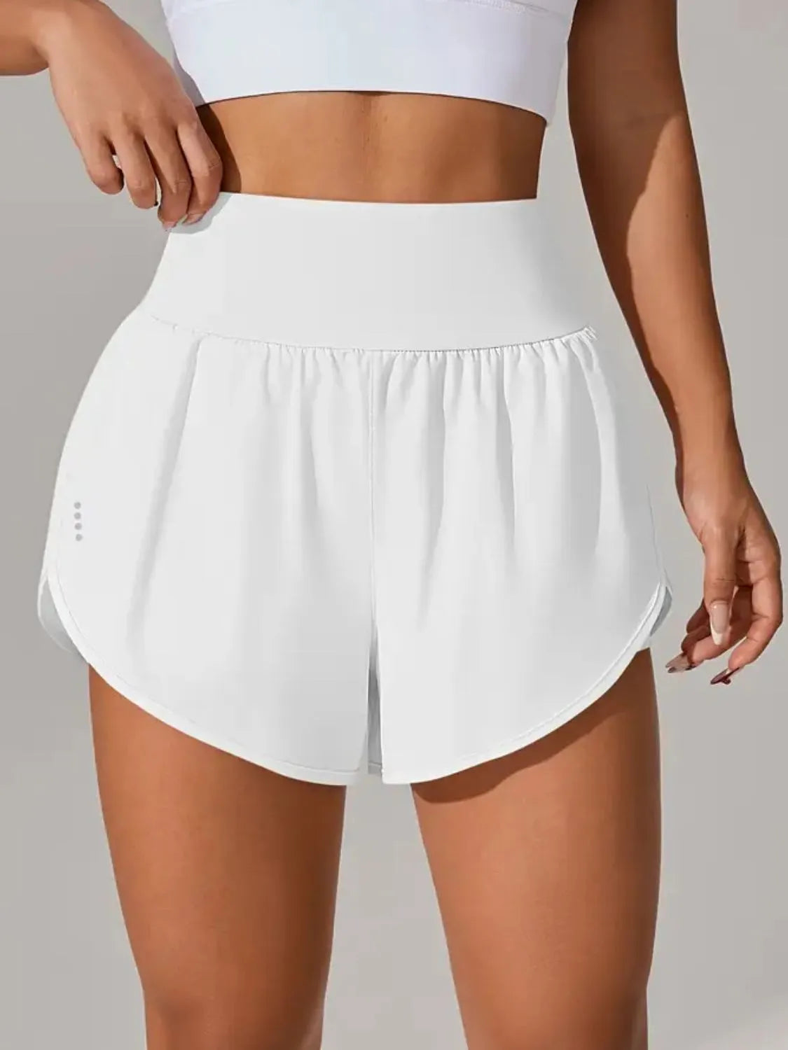 NEWYORKLISTED Activewear: White athletic shorts worn by a person on a neutral background