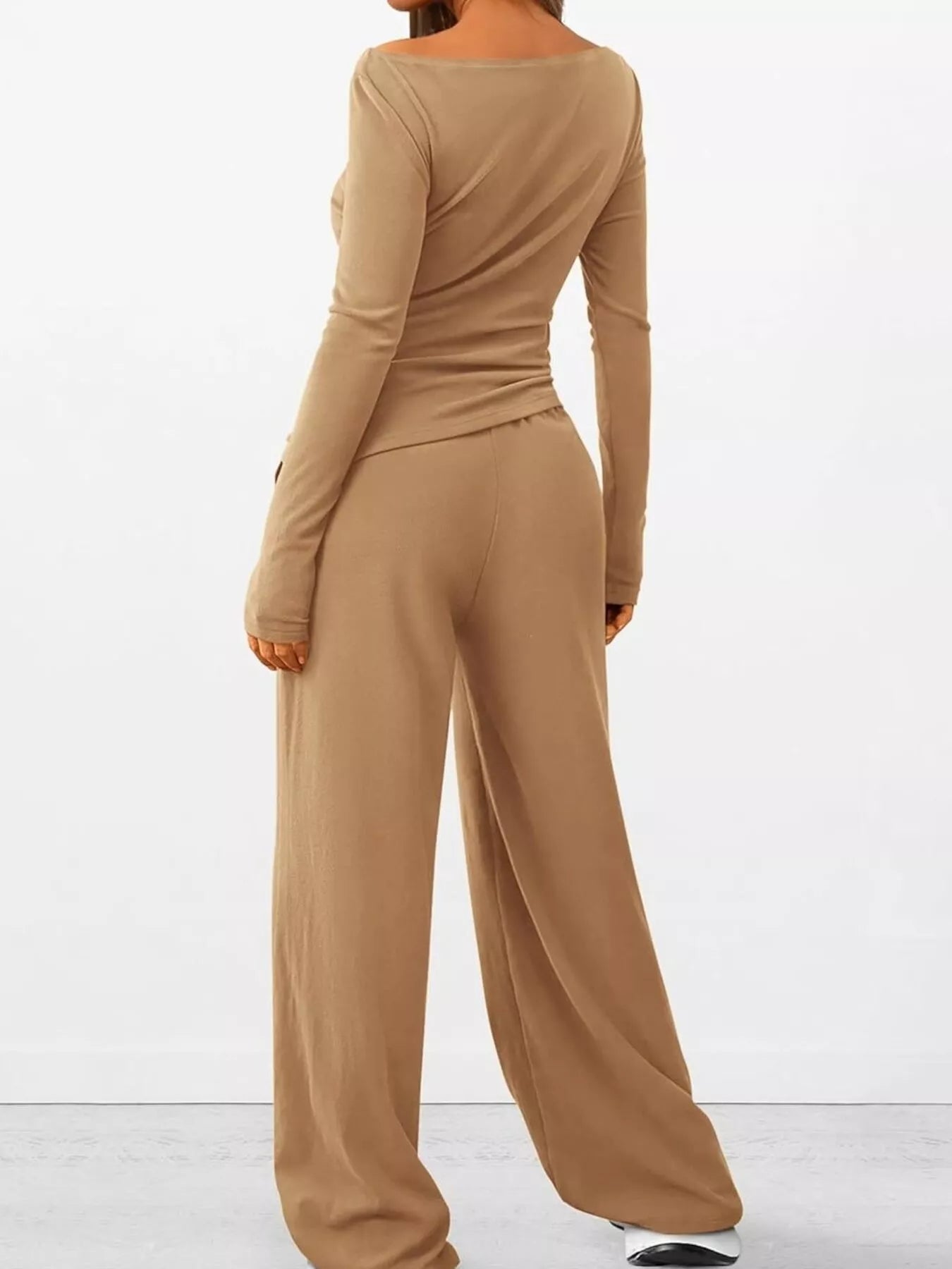 Beige long-sleeve top and wide-leg pants set on a white background