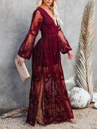 NEWYORKLISTED STYLE COLLECTION: Woman wearing a burgundy lace dress with sheer sleeves against a neutral background