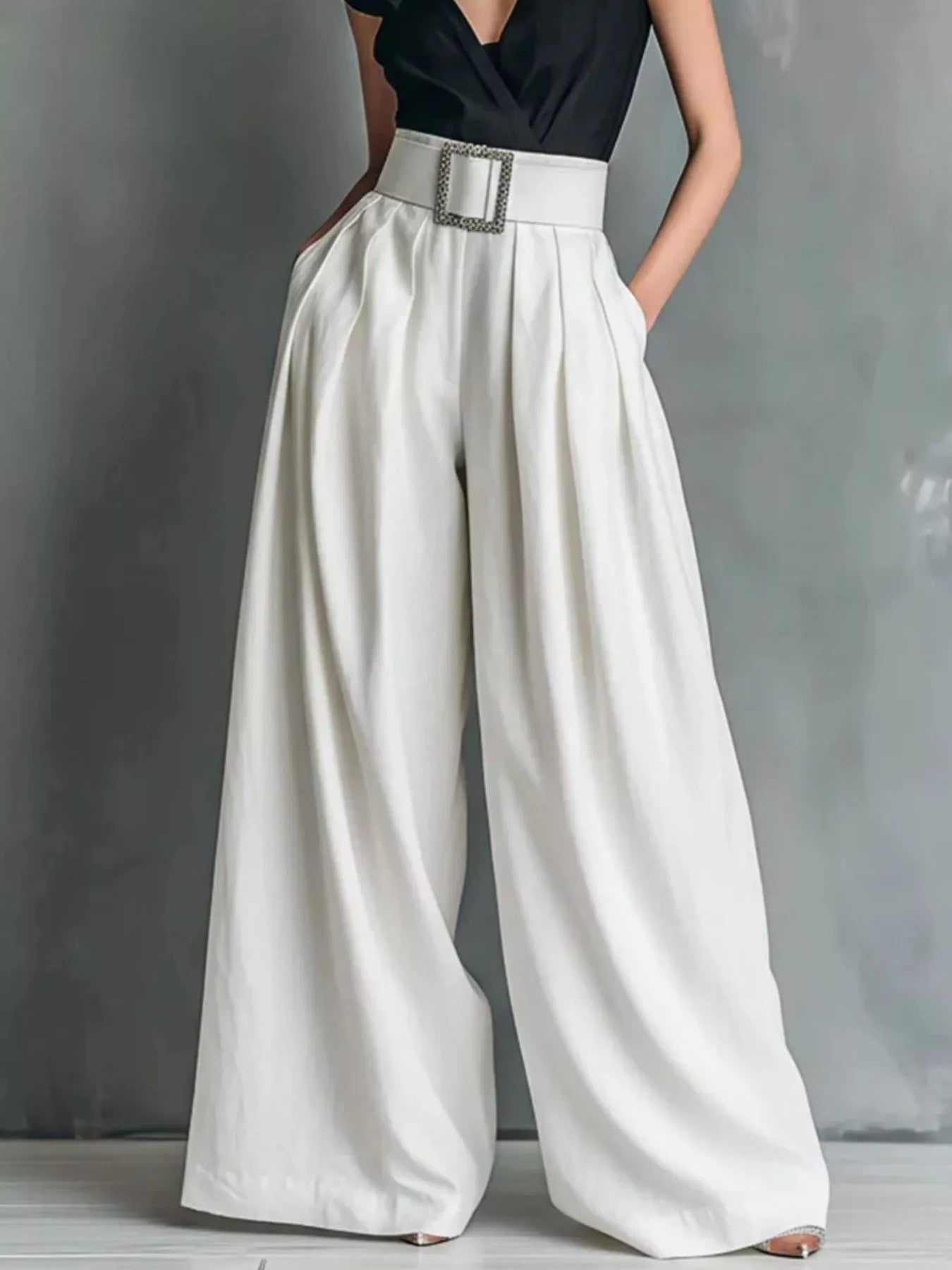 NEWYORKLISTED STYLE COLLECTION: White wide-leg pants worn with a black top on a gray background