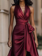 NEWYORKLISTED STYLE COLLECTION: Maroon satin dress worn by a model with a blurred background