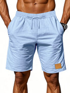 NEWYORKLISTED ATLAS MEN'S COLLECTION: Light blue shorts with a drawstring on a white background