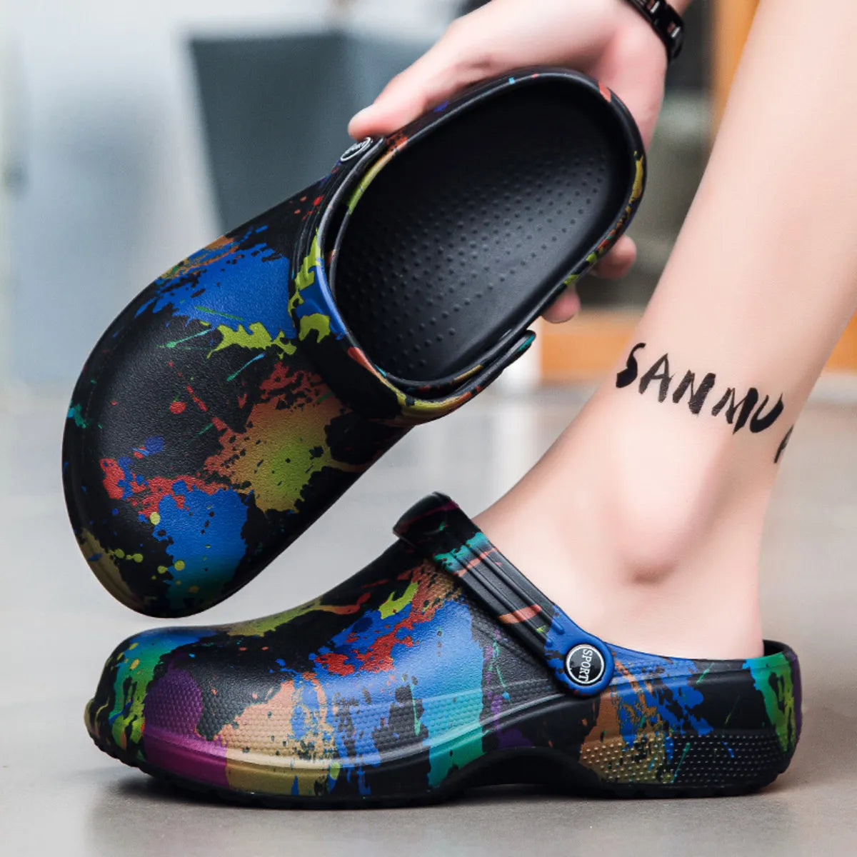 NEWYORKLISTED STYLE COLLECTION: Colorful splatter-patterned clogs being worn with a blurred background