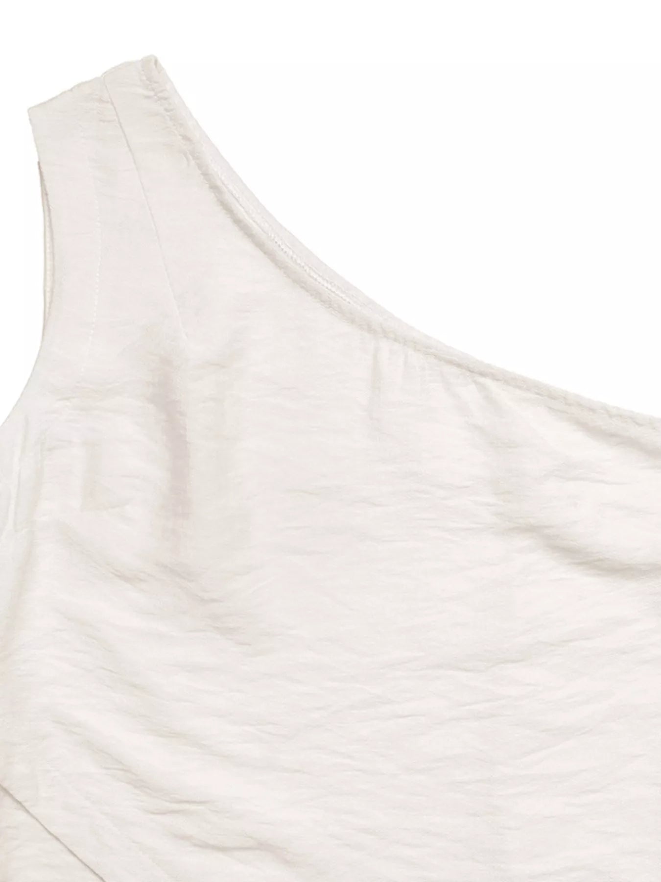NEWYORKLISTED STYLE COLLECTION: Close-up of a white one-shoulder top on a white background