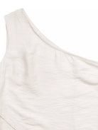 NEWYORKLISTED STYLE COLLECTION: Close-up of a white one-shoulder top on a white background