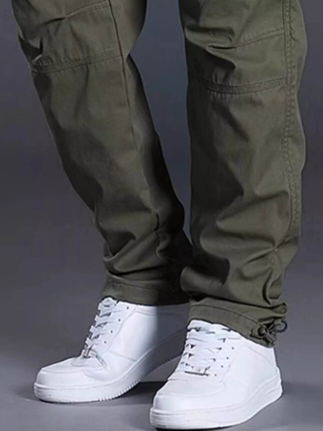 NEWYORKLISTED ATLAS MEN's COLLECTION: Green cargo pants with white sneakers on a gray background