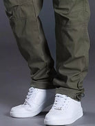 NEWYORKLISTED ATLAS MEN's COLLECTION: Green cargo pants with white sneakers on a gray background