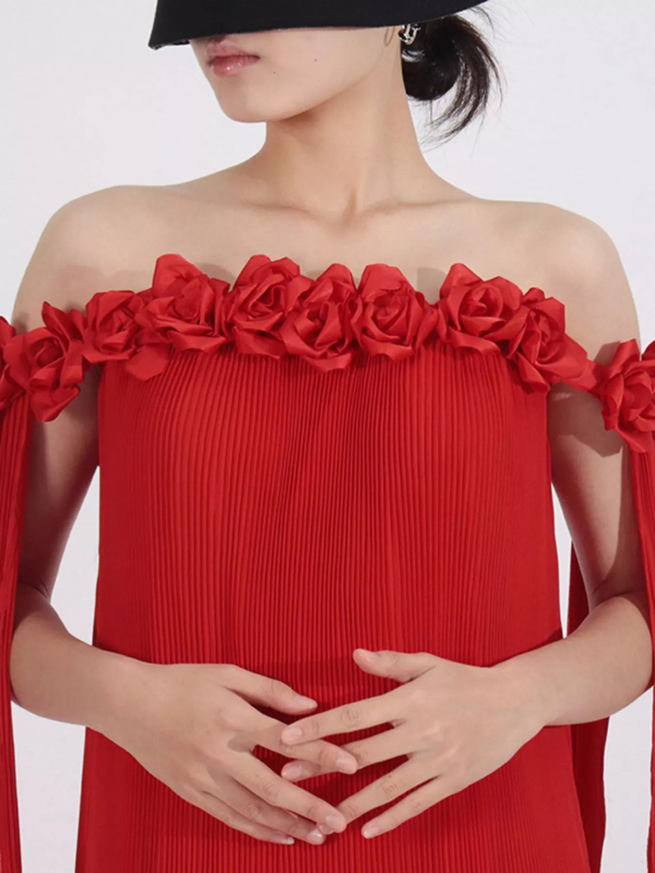 NEWYORKLISTED STYLE COLLECTION: Red off-shoulder dress with floral details on a white background