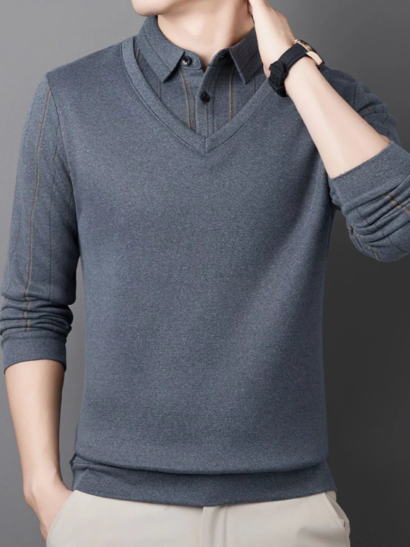 NEWYORKLISTED ATLAS MEN"S COLLECTION: Male model wearing a gray sweater with a collar against a dark background on the NEWYORKLISTED.COM website.