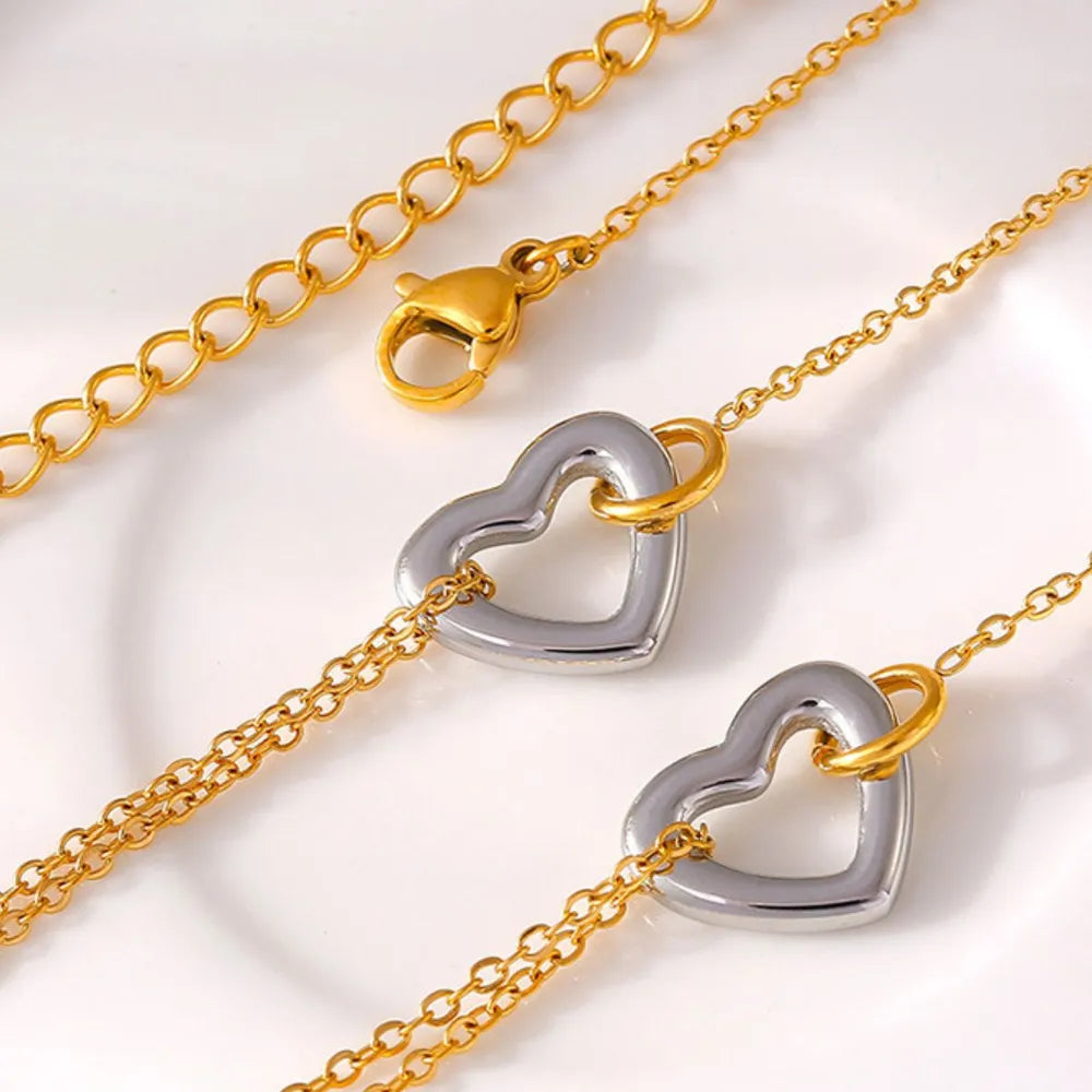 NEWYORKLISTED Valentine's Day Specials: Gold and silver heart-shaped clasp on a gold chain against a white background