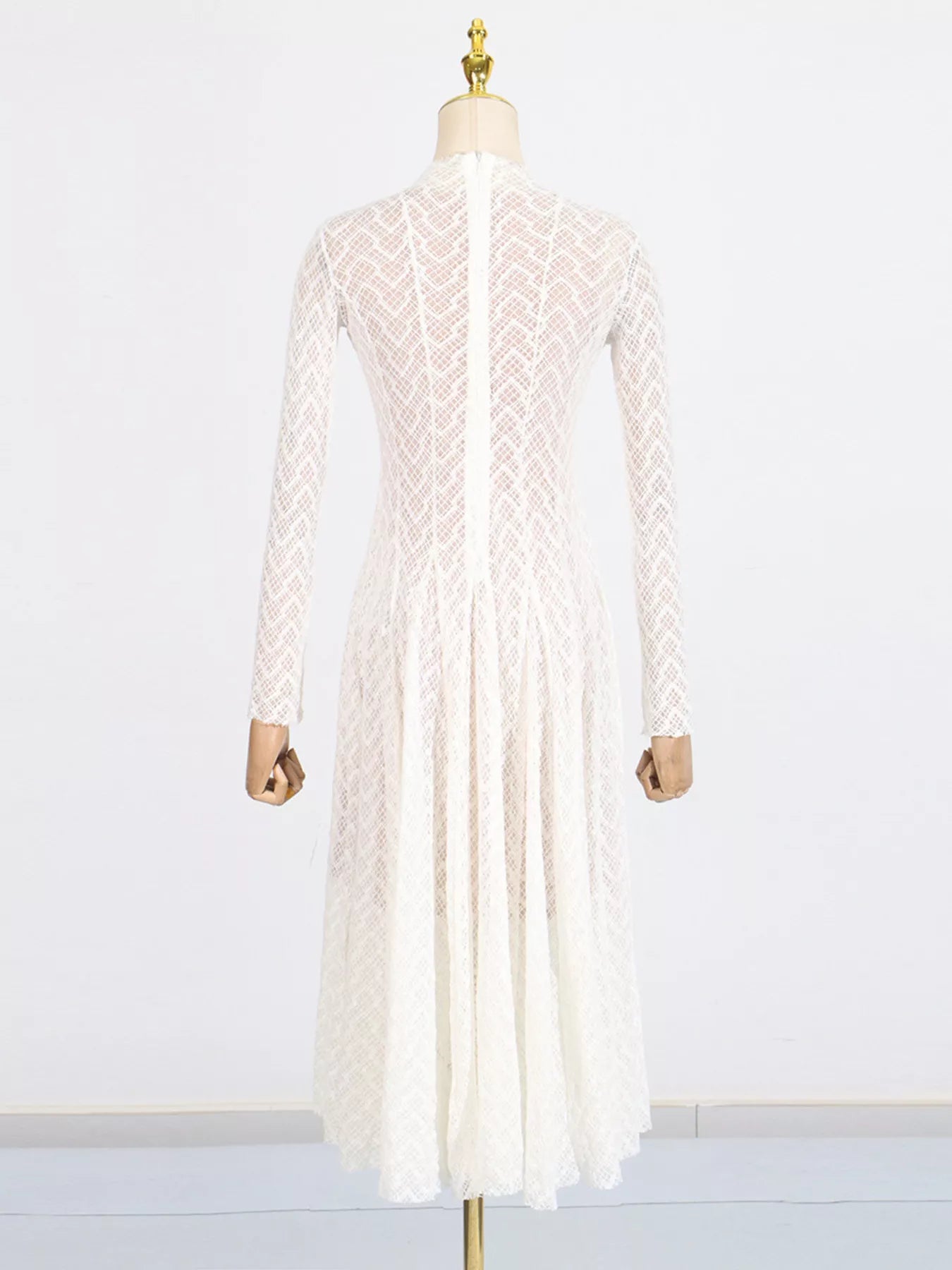NEWYORKLISTED STYLE COLLECTION: White lace dress on a mannequin against a white background