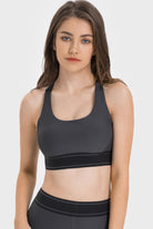 NEWYORKLISTED ACTIVEWEAR COLLECTION: Woman wearing a black sports bra and leggings on a white background